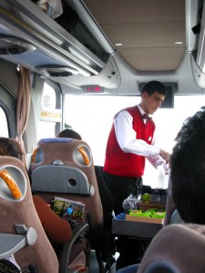 The bus attendant serving drinks - civilized bus travel.