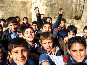 A group of schoolchildren eager to have their photo taken